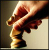Hand moving chess piece